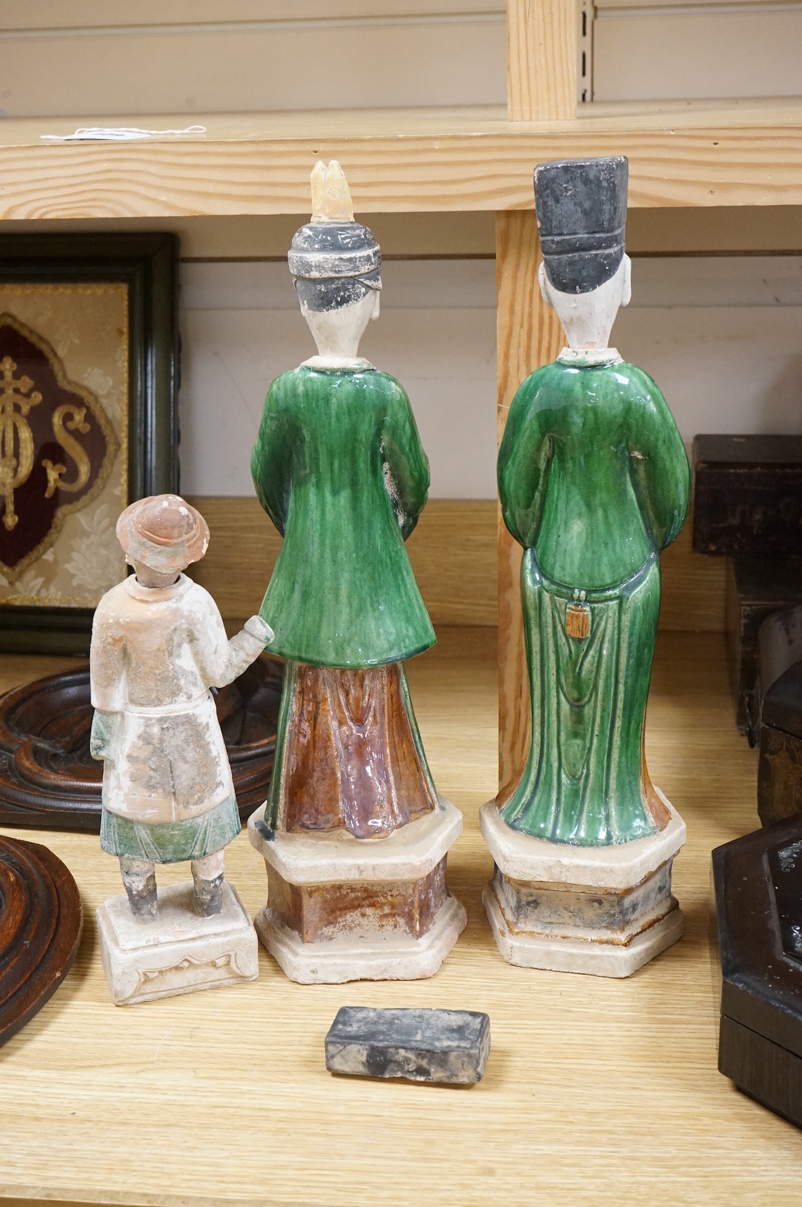 Three Chinese Ming sancai glazed figures of attendants, tallest figure 46cm